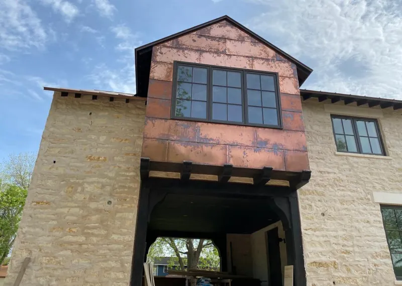 Copper metal panel facade on a stone building for Metal Roof Coating in Rochelle
