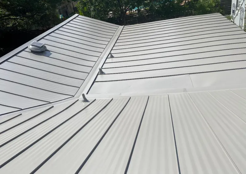Solar attic fan installed on a metal roof for Roof Ventilation in Rochelle