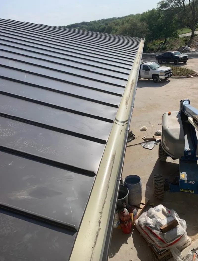 Standing seam panel and gutter detail on a metal roofing jobsite in Rochelle